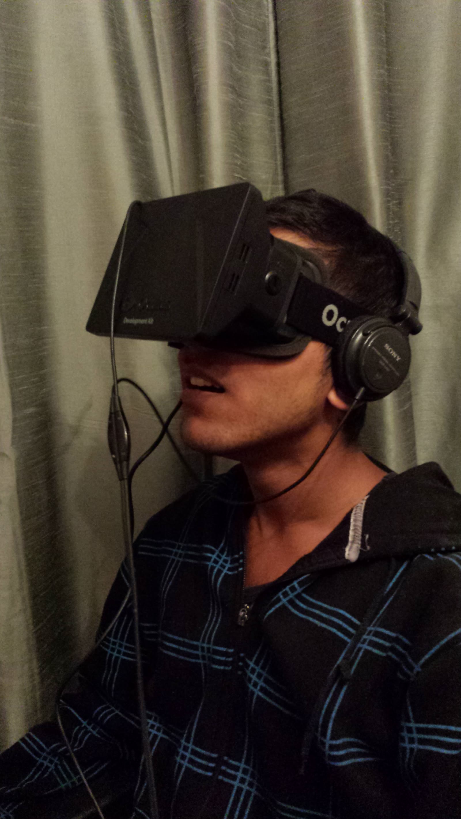 A younger David wearing an Oculus Rift DK1 headset for the first time