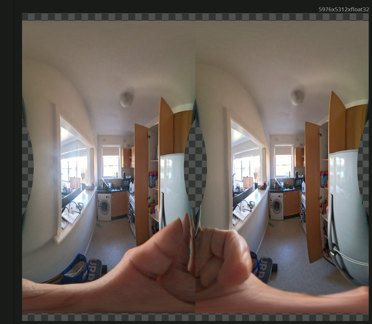 A side-by-side stereo VR180 frame of a kitchen, showing the washing machine, cabinets and a window, with a hand in the foreground