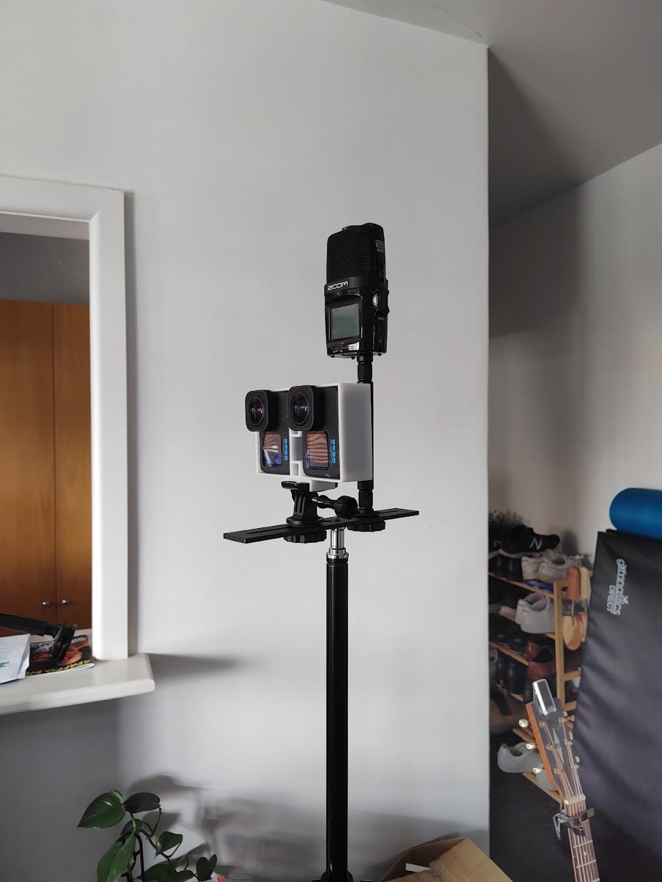 Two GoPro Hero 12 cameras side by side on a 3D-printed mount, with a Zoom H2n recorder mounted above, on a light stand